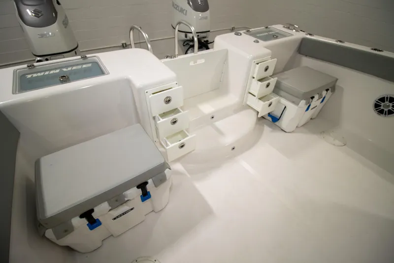 Slide: The Image of 2023 Twin Vee 340 GFX CC boat interior with storage compartments and Suzuki engines. - 37