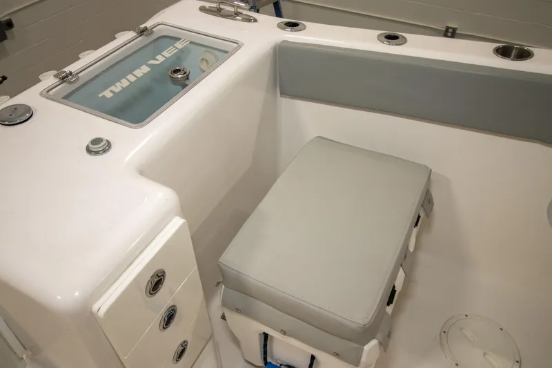 Slide: The Image of 2023 Twin Vee 340 GFX CC boat interior with cushioned seating and storage compartments. - 38