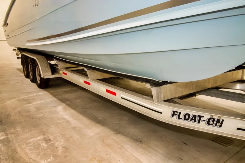 Slide: The Image of 2023 Twin Vee 340 GFX CC boat on a Float-On trailer in a garage. - 4