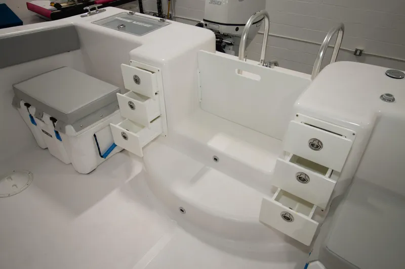 Slide: The Image of 2023 Twin Vee 340 GFX CC boat interior with storage drawers and cooler. - 40