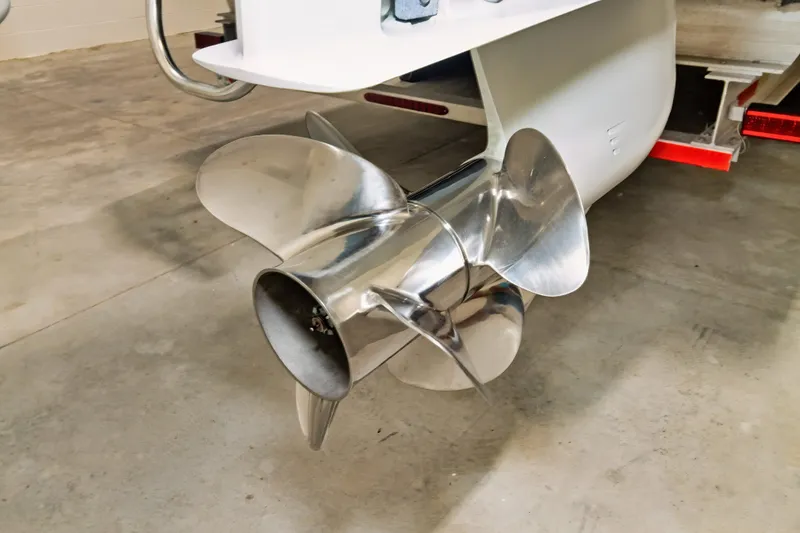 Slide: The Image of Stainless steel propeller of 2023 Twin Vee 340 GFX CC boat on trailer. - 42