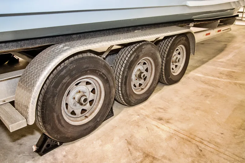 Slide: The Image of Trailer with three wheels supporting a 2023 Twin Vee 340 GFX CC boat. - 9