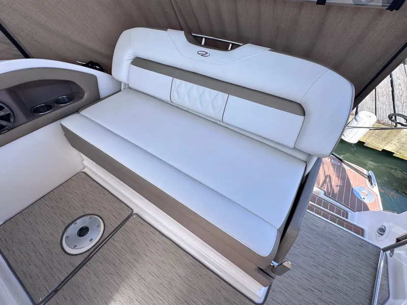 Slide: The Image of Interior of a 2018 Regal 28 Express boat with white seating. - 15
