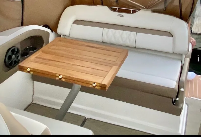 Slide: The Image of Interior of 2018 Regal 28 Express with wooden table and seating. - 22