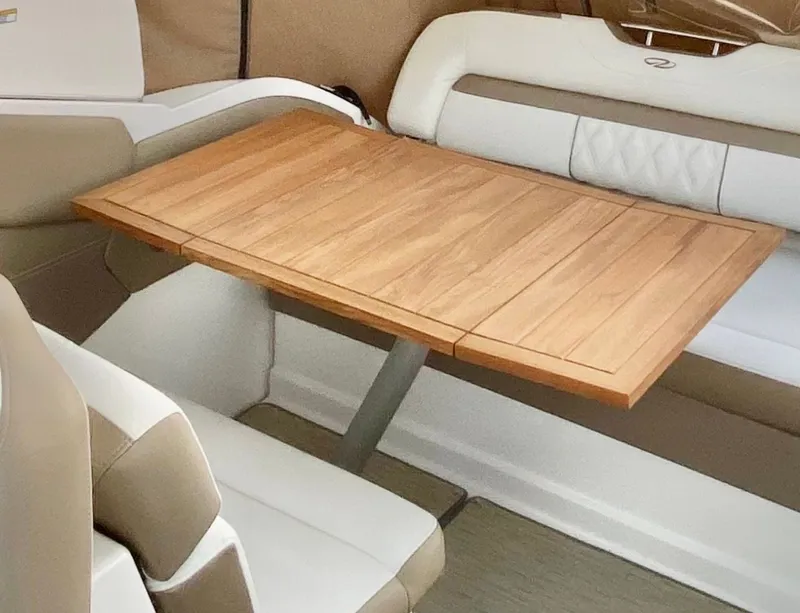 Slide: The Image of Interior of 2018 Regal 28 Express with wooden table and seating. - 23