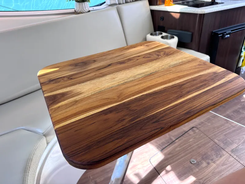 Slide: The Image of Interior of a 2018 Regal 28 Express with wooden table. - 27
