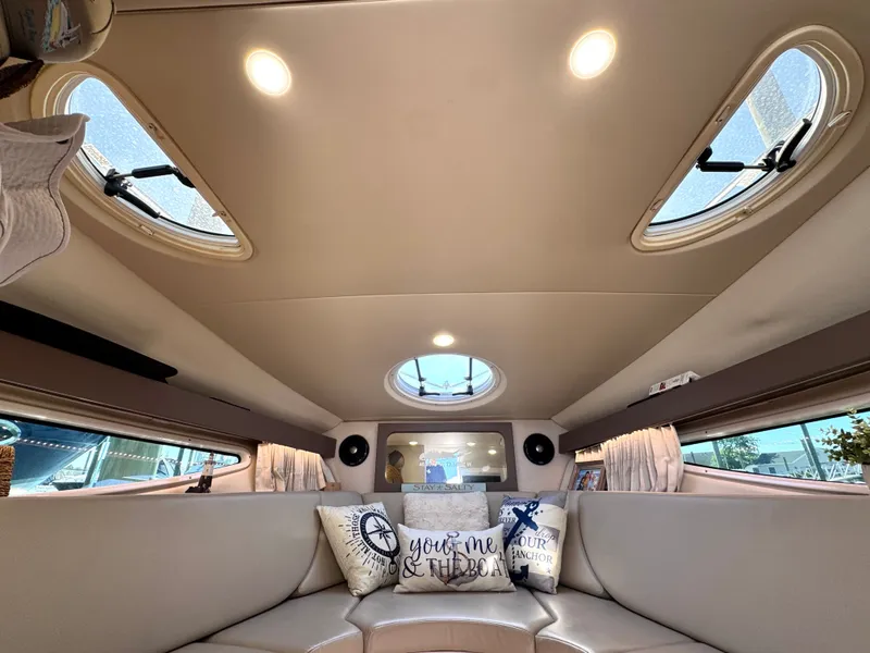 Slide: The Image of Interior of a 2018 Regal 28 Express boat with cushions and windows. - 3