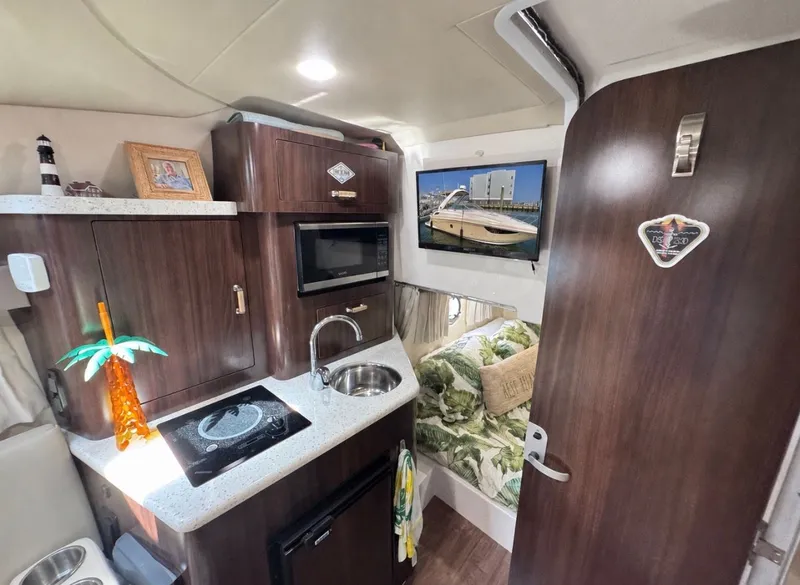 Slide: The Image of Interior of 2018 Regal 28 Express with kitchen and bed. - 31