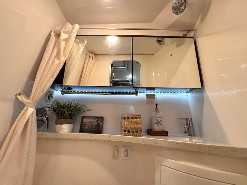 Slide: The Image of Interior of 2018 Regal 28 Express with mirror and sink. - 34