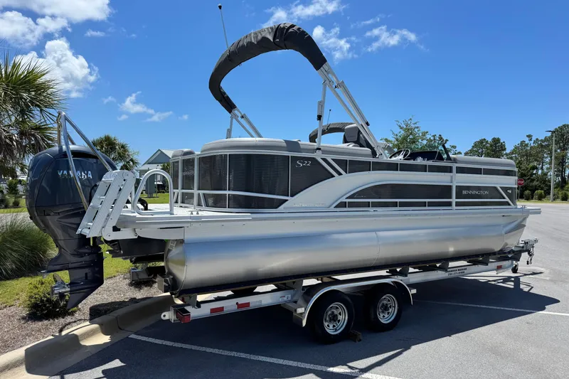 Slide: The Image of 2026 Bennington 22 SSR pontoon boat on trailer under clear blue sky. - 3