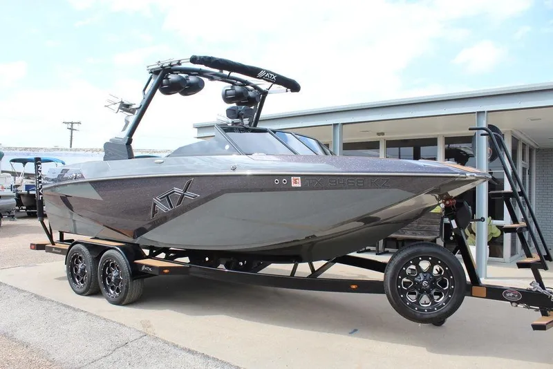 The Image of 2024 ATX Surf Boats 22 Type-S on trailer, sleek design, parked outdoors. - 0