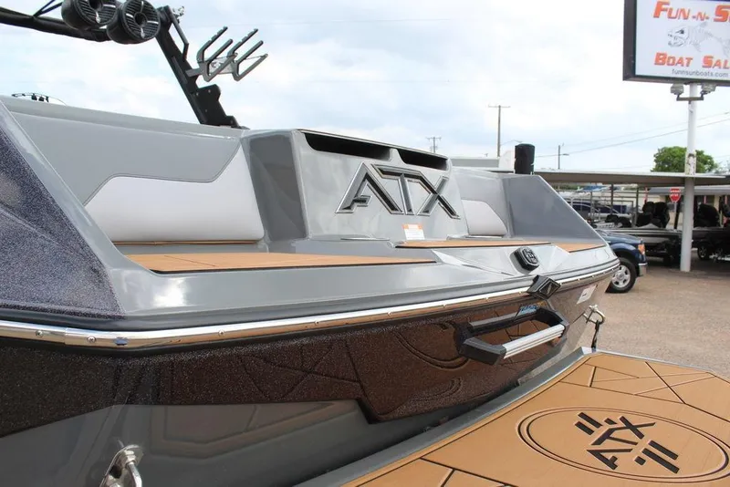 Slide: The Image of 2024 ATX Surf Boats 22 Type-S, sleek design with modern features, showcased at a boat dealership. - 13