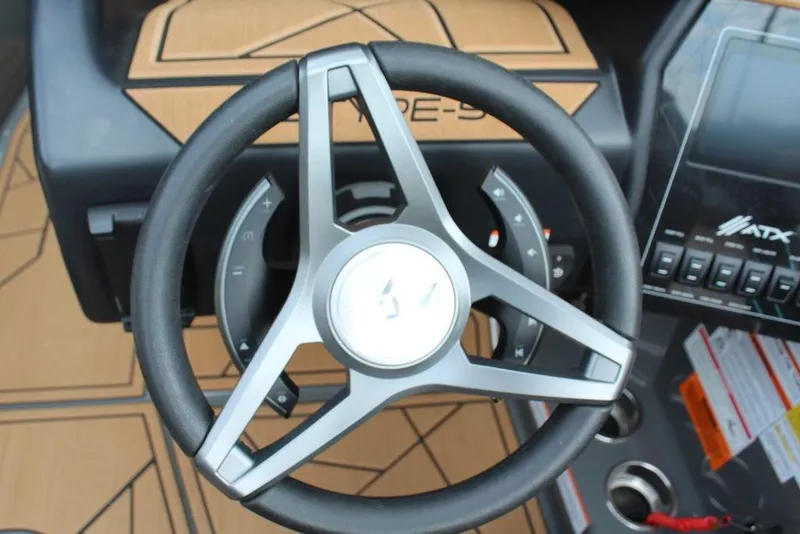 Slide: The Image of Steering wheel of 2024 ATX Surf Boats 22 Type-S with dashboard controls. - 14