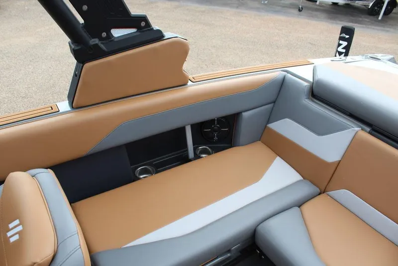 Slide: The Image of 2024 ATX Surf Boats 22 Type-S interior with tan and gray seating, featuring cup holders and speakers. - 16