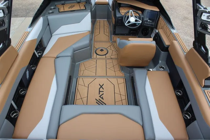 Slide: The Image of 2024 ATX Surf Boats 22 Type-S interior with tan and gray seating, modern dashboard, and stylish flooring. - 3