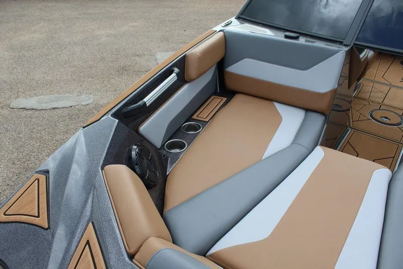 Slide: The Image of 2024 ATX Surf Boats 22 Type-S interior with tan and gray seating, cup holders, and speaker. - 31