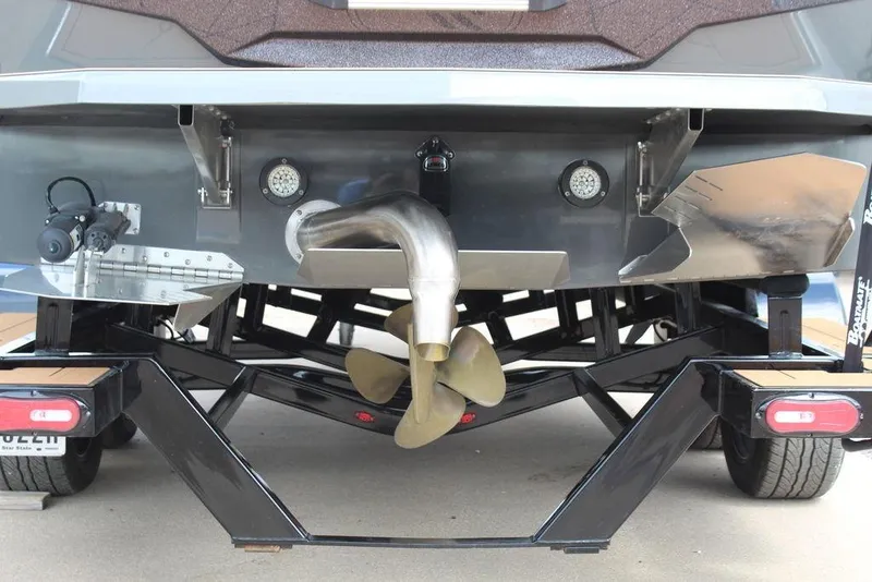 Slide: The Image of Rear view of 2024 ATX Surf Boats 22 Type-S on trailer, showcasing propeller and exhaust. - 33