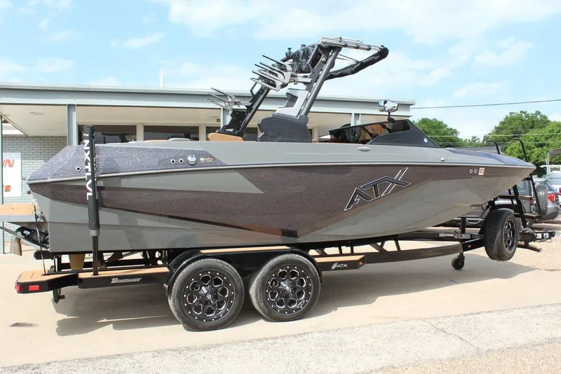 Slide: The Image of 2024 ATX Surf Boats 22 Type-S on trailer, sleek design, gray finish, parked outdoors. - 38