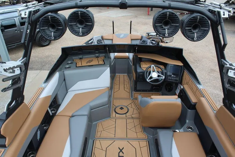 Slide: The Image of 2024 ATX Surf Boats 22 Type-S interior with tan and gray seating, advanced controls, and speakers. - 5