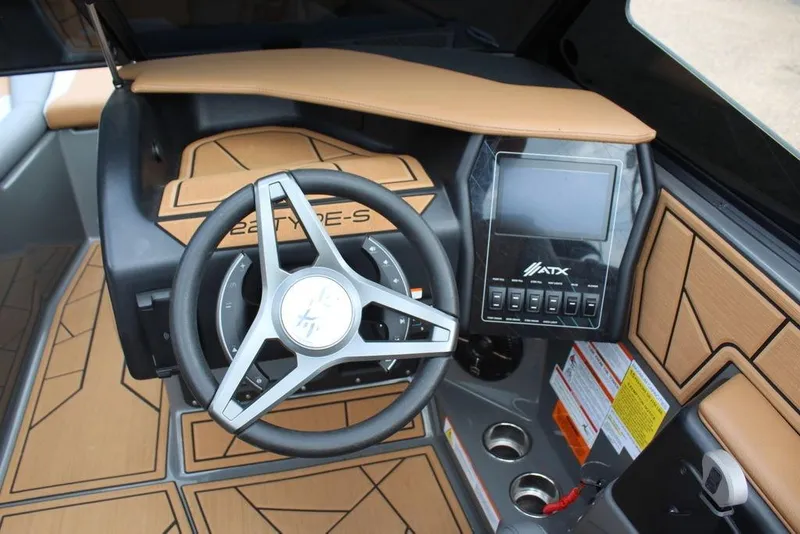 Slide: The Image of 2024 ATX Surf Boats 22 Type-S dashboard with steering wheel and control panel. - 6
