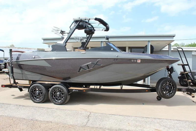Slide: The Image of 2024 ATX Surf Boats 22 Type-S on trailer, sleek design, parked outdoors. - 8