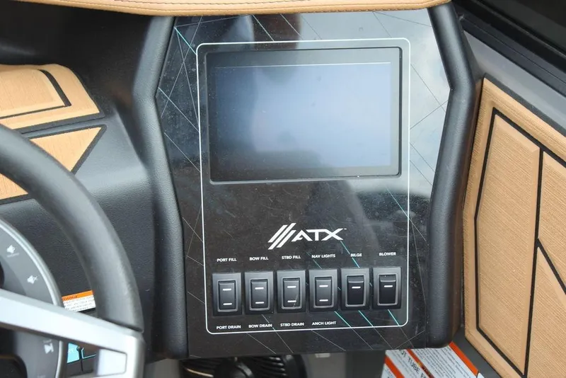 Slide: The Image of 2024 ATX Surf Boats 22 Type-S dashboard with touchscreen and control switches. - 9