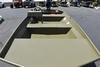 Slide: The Image of 2025 Lowe L1652MT Jon boat, olive green, parked outdoors on pavement. - 10