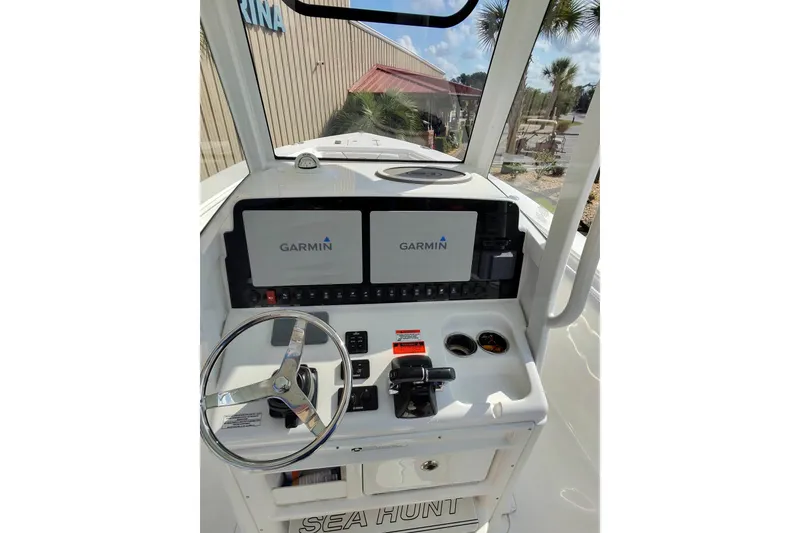 Slide: The Image of 2019 Sea Hunt Gamefish 27 helm with dual Garmin displays and steering wheel. - 14