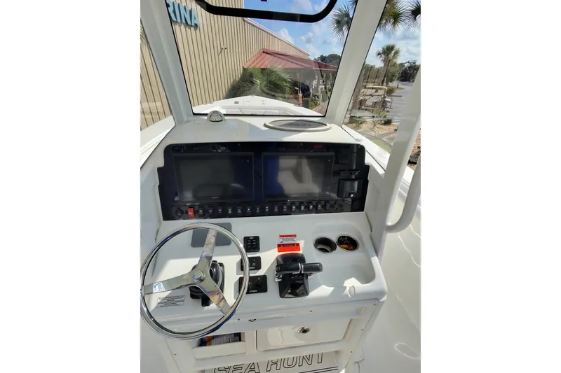 Slide: The Image of 2019 Sea Hunt Gamefish 27 helm with dual displays and steering wheel. - 15
