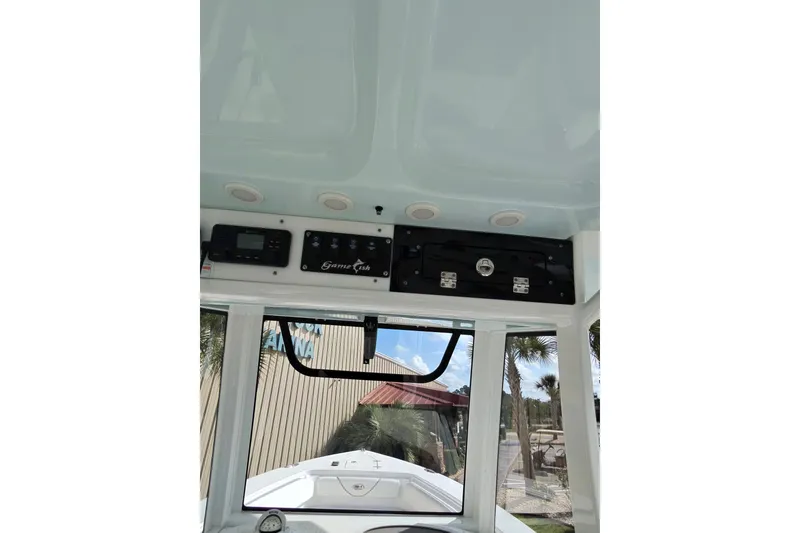 Slide: The Image of 2019 Sea Hunt Gamefish 27 boat interior dashboard with controls and overhead panel. - 16