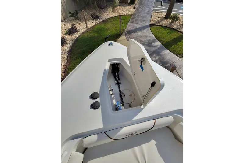 Slide: The Image of 2019 Sea Hunt Gamefish 27 boat with open storage compartment on deck. - 18