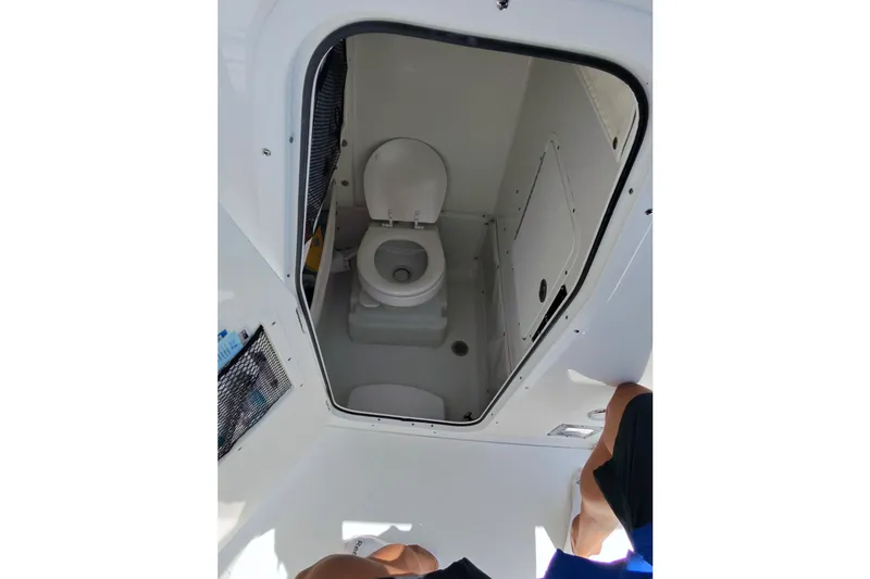 Slide: The Image of Interior view of 2019 Sea Hunt Gamefish 27 boat's compact marine toilet. - 21