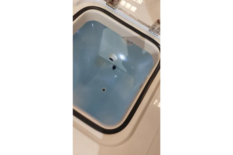 Slide: The Image of Livewell compartment in a 2019 Sea Hunt Gamefish 27 boat, featuring a clean interior. - 25