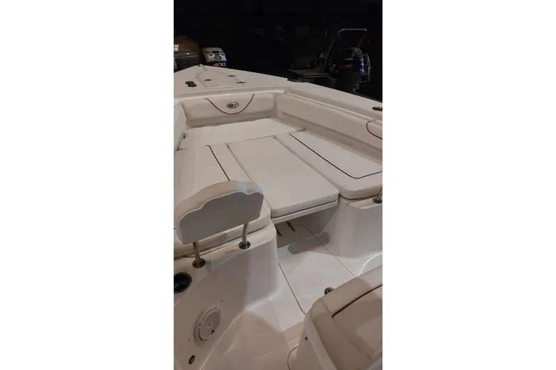 Slide: The Image of 2019 Sea Hunt Gamefish 27 boat interior with cushioned seating and storage compartments. - 27