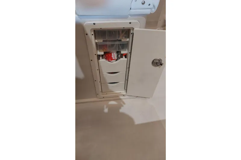 Slide: The Image of Storage compartment with drawers on a 2019 Sea Hunt Gamefish 27 boat. - 28