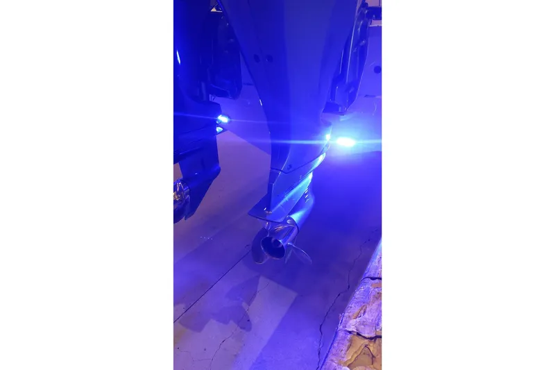 Slide: The Image of 2019 Sea Hunt Gamefish 27 boat with illuminated blue underwater lights. - 29