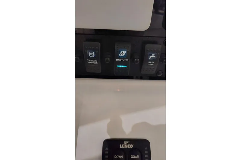 Slide: The Image of Control panel of a 2019 Sea Hunt Gamefish 27 boat with switches for baitwell, macerator, and washdown. - 33