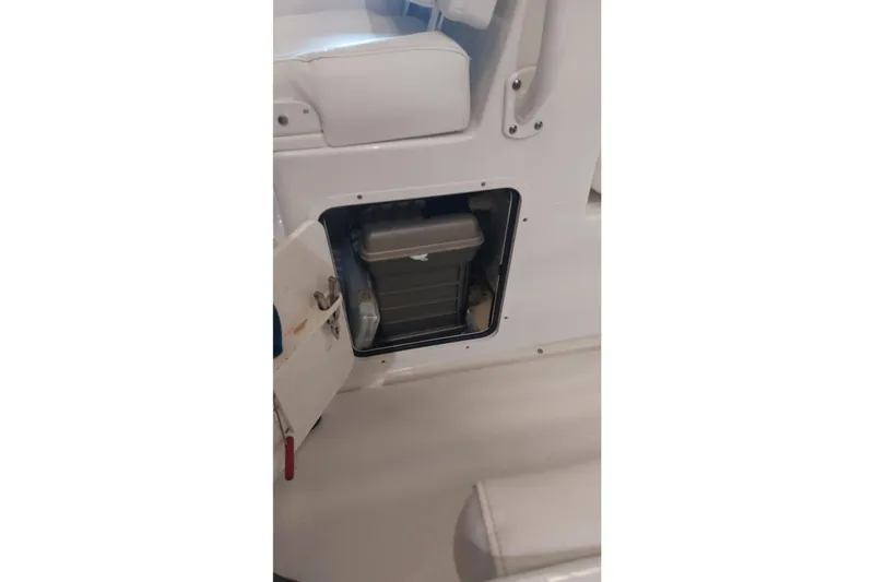 Slide: The Image of 2019 Sea Hunt Gamefish 27 storage compartment with open hatch, showcasing interior space. - 35