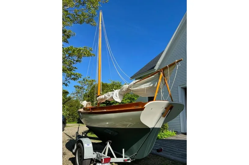 Slide: The Image of Herreshoff 12 1/2 sailboat from 2003 on a trailer, set against a clear blue sky. - 2