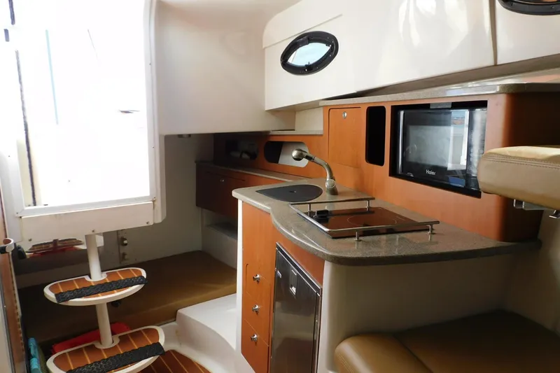 Slide: The Image of Interior of 2012 Sailfish 30-06 Express boat with modern kitchen amenities. - 10