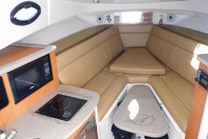 Slide: The Image of Interior of 2012 Sailfish 30-06 Express boat with cozy seating and kitchenette. - 11