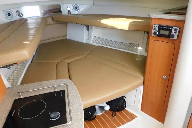 Slide: The Image of Interior of 2012 Sailfish 30-06 Express boat with cozy seating and compact kitchen area. - 16