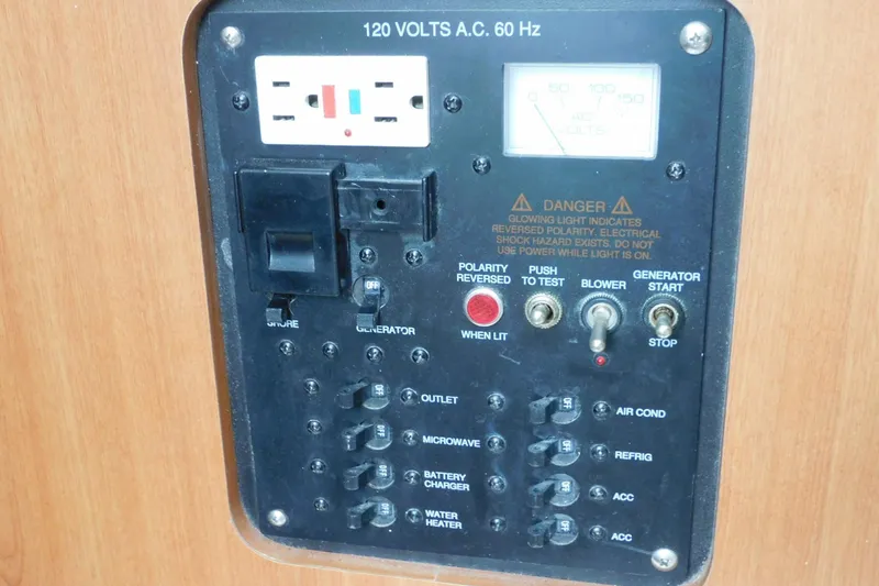 Slide: The Image of Electrical control panel on a 2012 Sailfish 30-06 Express boat, featuring switches and outlets. - 19