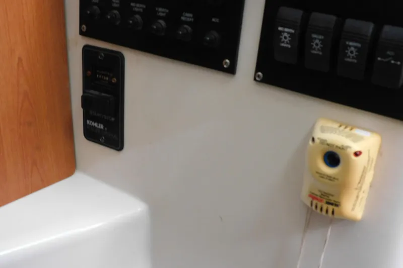 Slide: The Image of Control panel of a 2012 Sailfish 30-06 Express boat with switches and a Kohler start/stop button. - 20