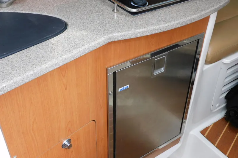 Slide: The Image of Compact kitchenette in 2012 Sailfish 30-06 Express boat with stainless steel fridge. - 22