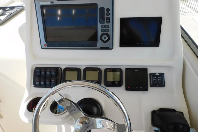 Slide: The Image of Control panel of a 2012 Sailfish 30-06 Express boat with navigation instruments. - 4