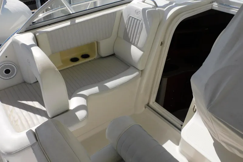 Slide: The Image of Interior seating of a 2012 Sailfish 30-06 Express boat, featuring white upholstery. - 8