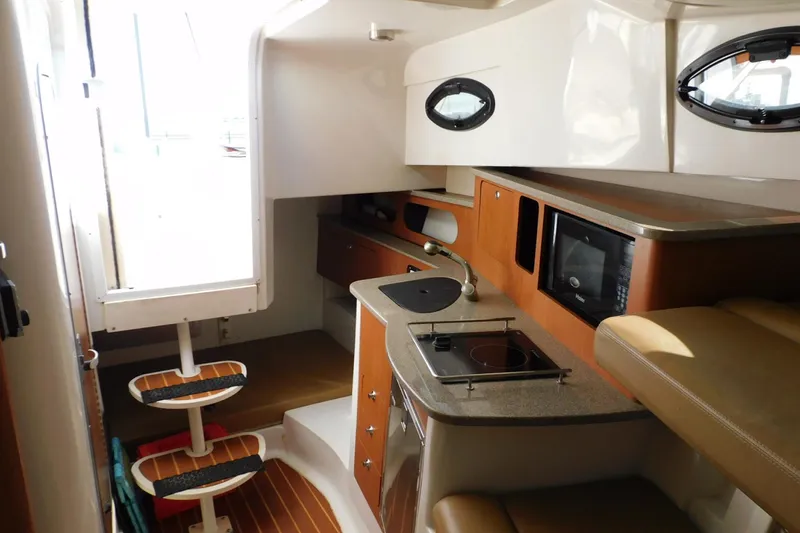 Slide: The Image of Interior of 2012 Sailfish 30-06 Express boat with kitchenette and seating area. - 9