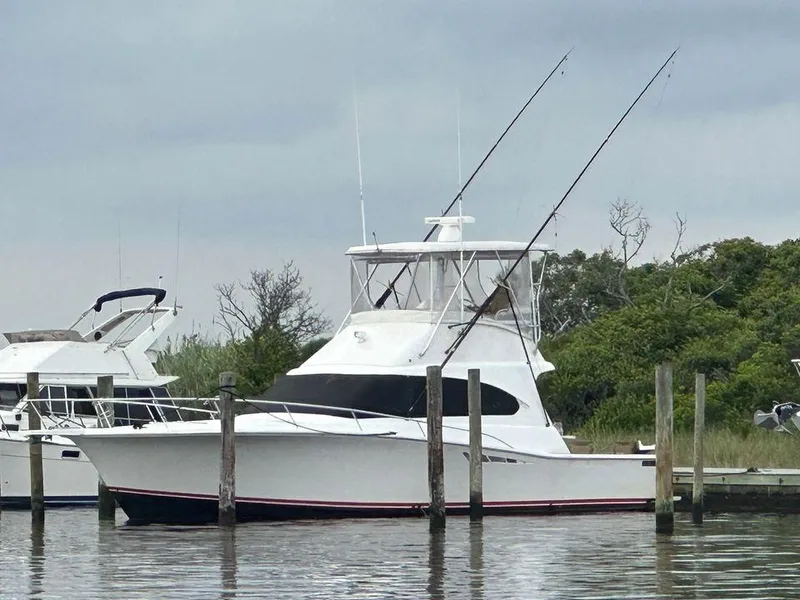 The Image of 1993 Luhrs Tournament 380 Convertible yacht docked at marina, overcast sky. - 0