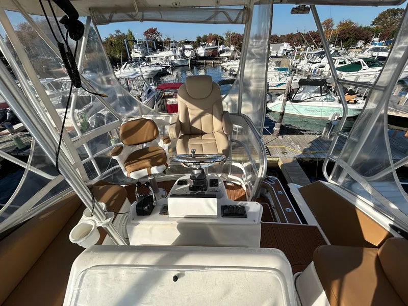 Slide: The Image of 1993 Luhrs Tournament 380 Convertible boat interior with helm and seating at marina. - 10